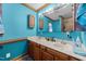 Bathroom with a double sink vanity, wooden cabinets and drawers, and a large mirror at 3405 Wilsons Mills Rd, Smithfield, NC 27577