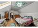 Attic bedroom with sloped ceilings, wood floors, and a quirky painted skylight at 3405 Wilsons Mills Rd, Smithfield, NC 27577
