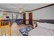 Bedroom with wood floors and trim, a ceiling fan and large windows at 3405 Wilsons Mills Rd, Smithfield, NC 27577