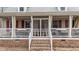 Inviting front porch with white railings and red shutters at 3405 Wilsons Mills Rd, Smithfield, NC 27577