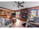 Bright living room with fireplace, ceiling fan, wood trim and flooring at 3405 Wilsons Mills Rd, Smithfield, NC 27577