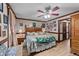 Cozy main bedroom features a ceiling fan and a decorative bed with floral patterned bedding at 3405 Wilsons Mills Rd, Smithfield, NC 27577