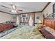 Bright main bedroom features a decorative wooden bed frame and floral-patterned bedding at 3405 Wilsons Mills Rd, Smithfield, NC 27577