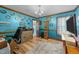 Home office space features blue walls, built-in shelving, and wood-look flooring at 3405 Wilsons Mills Rd, Smithfield, NC 27577