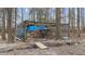 Fenced in chicken coop sits among the trees in the backyard at 3405 Wilsons Mills Rd, Smithfield, NC 27577