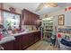 Pantry area with wood cabinets, granite countertops, and linoleum flooring at 3405 Wilsons Mills Rd, Smithfield, NC 27577