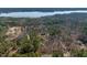 An aerial view of a wooded lot with a home near the lake at 38 Kingbird Ln, Chapel Hill, NC 27517