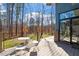 Enjoy outdoor living on this deck with forest views and a table with seating at 38 Kingbird Ln, Chapel Hill, NC 27517
