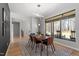 Modern dining room featuring a wood table, black chairs, and large window with wooded views at 38 Kingbird Ln, Chapel Hill, NC 27517