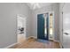 Bright entryway with light wood floors, a striking blue door, and access to a functional home office at 38 Kingbird Ln, Chapel Hill, NC 27517