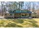 Charming brick two-story home features a covered front porch and a well-manicured lawn and landscaping at 38 Kingbird Ln, Chapel Hill, NC 27517