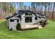 Stunning home with lush lawn, mature trees, and a multi-level deck, virtually enhanced at 38 Kingbird Ln, Chapel Hill, NC 27517
