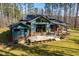 Beautiful home with lush lawn, mature trees, and a multi-level deck and covered porch at 38 Kingbird Ln, Chapel Hill, NC 27517