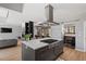 Spacious kitchen with a center island cooktop, views of dining room, living room, and barndoor pantry at 38 Kingbird Ln, Chapel Hill, NC 27517