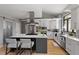 Contemporary kitchen with stainless steel appliances, center island, and sleek white cabinetry at 38 Kingbird Ln, Chapel Hill, NC 27517