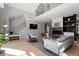 Elegant living room with fireplace, hardwood floors, modern staircase, and comfortable seating area at 38 Kingbird Ln, Chapel Hill, NC 27517