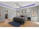 Comfortable bedroom with a ceiling fan, hardwood floors, and natural light streaming through multiple windows at 38 Kingbird Ln, Chapel Hill, NC 27517