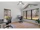 Bright office boasts large windows, two desks, wood floors, and ample natural light overlooking the wooded property at 38 Kingbird Ln, Chapel Hill, NC 27517