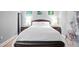 Comfortable bedroom with a large bed, art decorations, and a black folding screen at 400 W North St # 804, Raleigh, NC 27603