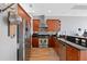 Modern kitchen with stainless steel appliances, dark countertops, and wood cabinetry at 400 W North St # 804, Raleigh, NC 27603