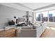 Open living room with large windows offering natural light and city views with contemporary decor at 400 W North St # 804, Raleigh, NC 27603