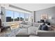 Cozy living room with large windows and modern furniture arrangement with an open floorplan at 400 W North St # 804, Raleigh, NC 27603