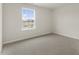 A simple bedroom with carpet flooring, a large window, and neutral walls at 411 Leven Dr, Gibsonville, NC 27249