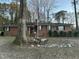 Charming brick home featuring a well-maintained front yard, beautiful landscaping and mature trees at 431 S Harrison Ave, Cary, NC 27511