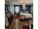 Luxurious bedroom featuring a king-sized bed, elegant chandelier, and chic decor, creating a serene retreat at 431 S Harrison Ave, Cary, NC 27511