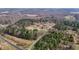 Beautiful aerial view of home nestled amongst mature trees on acreage at 4420 Bunton Swaim Rd, Liberty, NC 27298