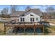View of the large back deck with outdoor seating and a grill at 4420 Bunton Swaim Rd, Liberty, NC 27298