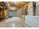 Unfinished basement space with concrete floors, exposed beams, and ample storage at 4420 Bunton Swaim Rd, Liberty, NC 27298