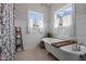 Clawfoot soaking tub in bathroom is surrounded by windows offering ample natural light at 4420 Bunton Swaim Rd, Liberty, NC 27298