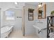 Charming bathroom with a clawfoot tub, shiplap walls, and vintage-inspired fixtures at 4420 Bunton Swaim Rd, Liberty, NC 27298