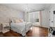 Bright bedroom with a chandelier, hardwood floors, floral wallpaper and natural light at 4420 Bunton Swaim Rd, Liberty, NC 27298