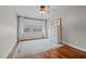 Bedroom with hardwood floors, a ceiling fan, and a large window providing natural light at 4420 Bunton Swaim Rd, Liberty, NC 27298