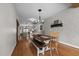 Spacious dining area with wood floors and a stylish light fixture over the large dining table at 4420 Bunton Swaim Rd, Liberty, NC 27298