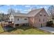Rear exterior view of a brick and siding home with a metal roof and a deck at 4420 Bunton Swaim Rd, Liberty, NC 27298