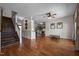 Open-concept living space with hardwood floors, shiplap accent wall, and staircase at 4420 Bunton Swaim Rd, Liberty, NC 27298