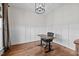 Office space with board and batten walls, wood floors, and modern light fixture at 4420 Bunton Swaim Rd, Liberty, NC 27298