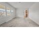 Bright living room featuring neutral carpet, and abundant natural light from large windows at 461 Camp Rd, Burlington, NC 27217