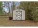 Storage shed with double doors is placed in the backyard at 461 Camp Rd, Burlington, NC 27217