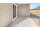 Concrete patio with sliding glass door entrance and light tan vinyl siding at 488 Lochalsh Dr, Gibsonville, NC 27249