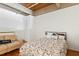 Bedroom with a sofa, closet and modern bed features exposed ceiling beams and hardwood floors at 500 N Duke St # 53104, Durham, NC 27701