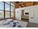 Bedroom with a view of the neighborhood features a large window, hardwood floors, and a comfortable sofa at 500 N Duke St # 53104, Durham, NC 27701