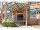 Close up of the covered entry, BAY 53, for the brick condominium building featuring metal steps and a bush at 500 N Duke St # 53104, Durham, NC 27701