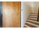 View of the entryway features a wood front door and a staircase to the upper level at 500 N Duke St # 53104, Durham, NC 27701