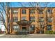 Charming brick condominium building with covered entrance, well-maintained landscaping, and mature trees at 500 N Duke St # 53104, Durham, NC 27701