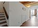 Hallway featuring hardwood floors and a view into the sunlit living room and stairs to the left at 500 N Duke St # 53104, Durham, NC 27701