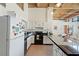 Bright kitchen features white cabinets, black appliances, and countertop seating at 500 N Duke St # 53104, Durham, NC 27701